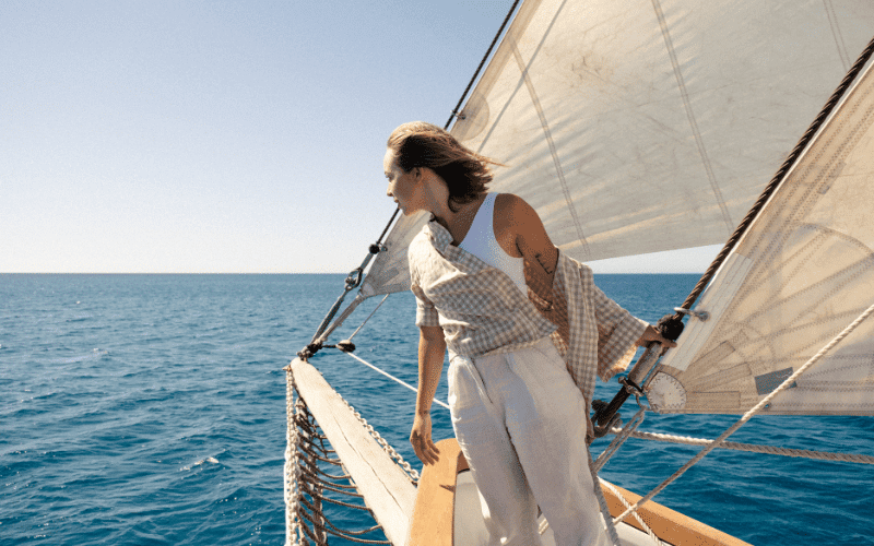 Women sailing together, taking charge on the deck, navigating through the open sea with determination and unity